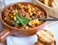 zucchini corn relish in terracotta Mediterranean dish