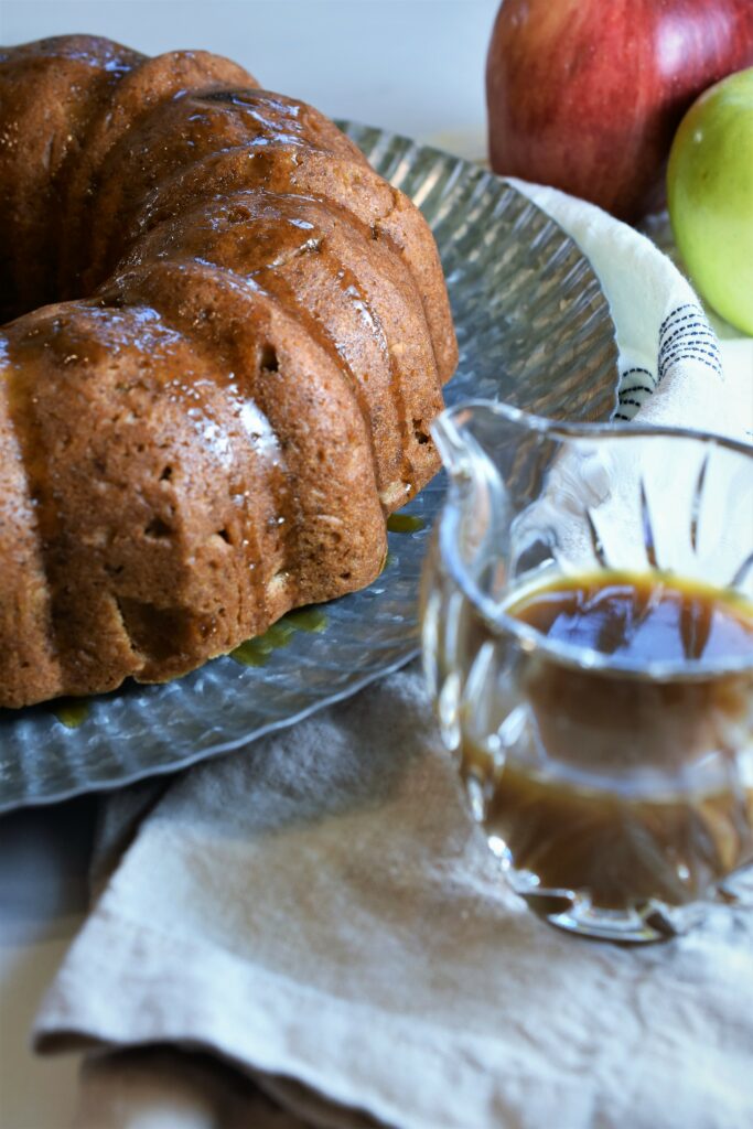 vegan apple Bundt cake with brown sugar glaze on galvanized tray
