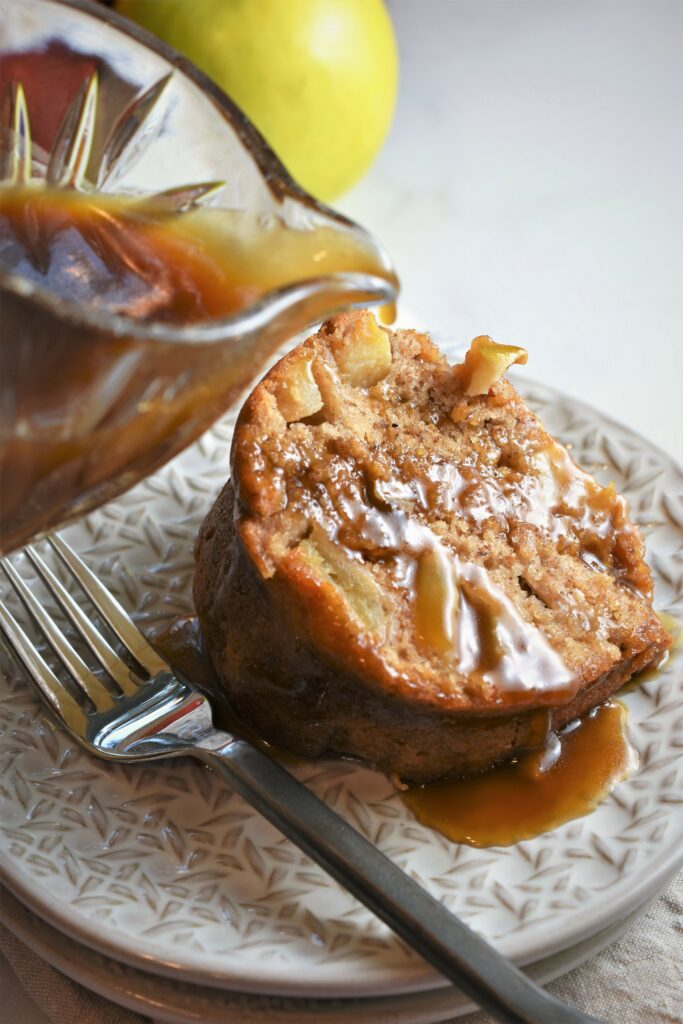 brown sugar glaze being poured onto cake slice