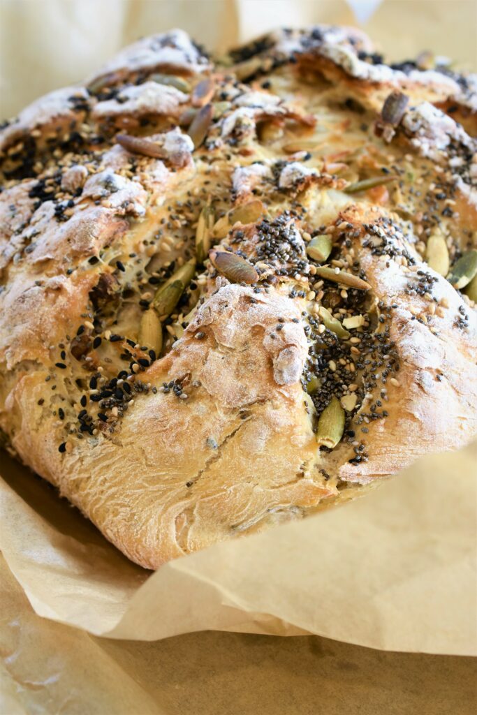 crazy Dutch oven bread right out of the oven on parchment