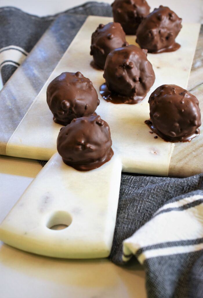 gray and white marble board displayed with peanut butter s'more bombs on denim and white striped towel 