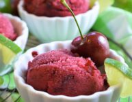 frozen dessert in mini white ceramic scalloped bowls on black round wire cooling rack on top of green and white checkered napkin