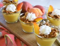 a group of 5 vegan peaches and cream pudding cups on board