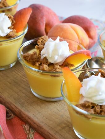 a group of 5 vegan peaches and cream pudding cups on board