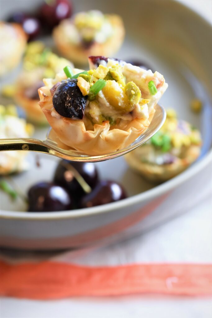 gold spoon serving up an appetizer