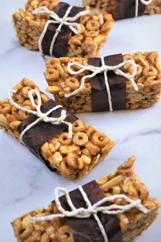 several wrapped apple crisp cereal bars on marble counter top