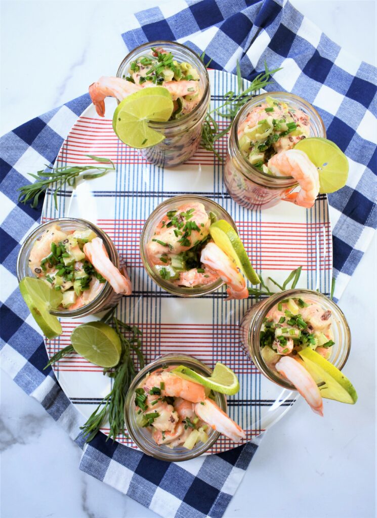 overhead view of fresh summer watermelon and shrimp salad in glasses