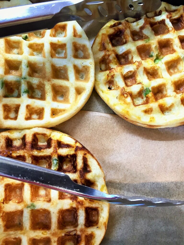 just cooked breakfast on parchment paper with tongs