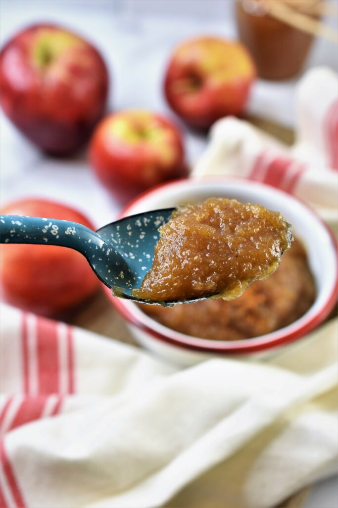 up close blue enameled spoonful of applesauce