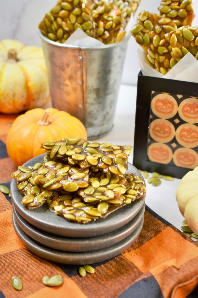 stacks of pumpkin seed brittle on mini appetizer plates