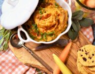 fall appetizer dip in white bowl on cutting board