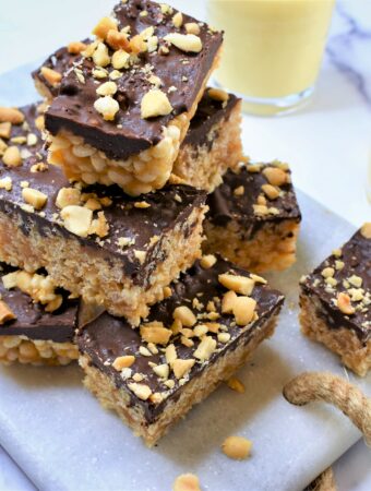 rice crispy treats with dark chocolate and peanut butter on white marble countertop